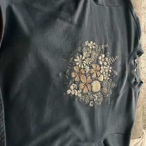 Blue Vans t-shirt with embroidered floral pattern on it.